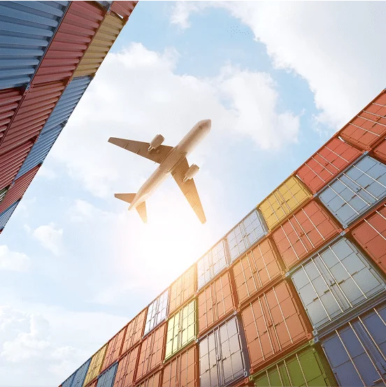 plane flying over cargo containers