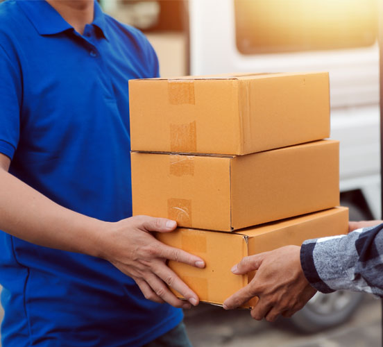 someone handing 3 boxes to another person