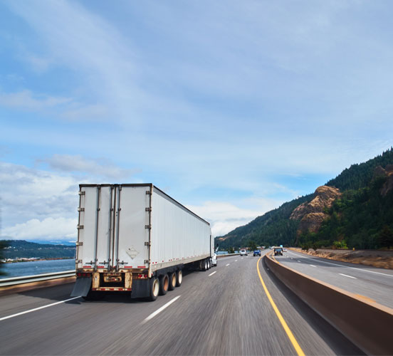 Truck driving alongside a river